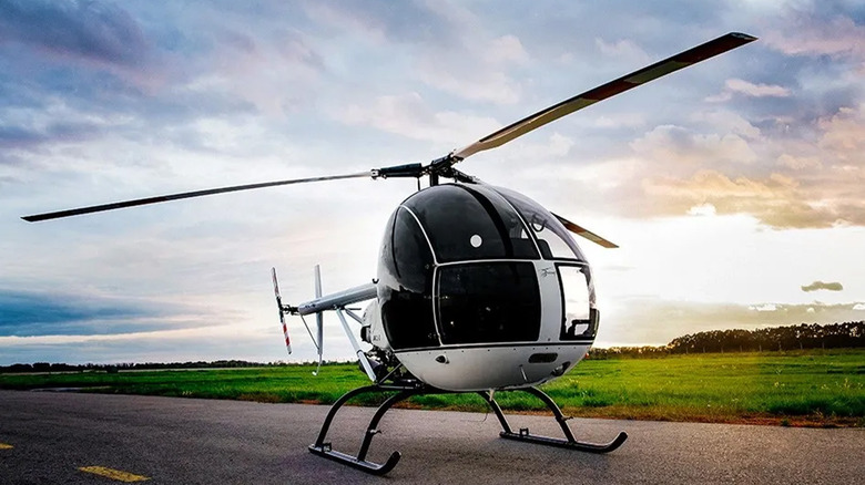 An AK1-3 Sanka helicopter on a runway at sunset