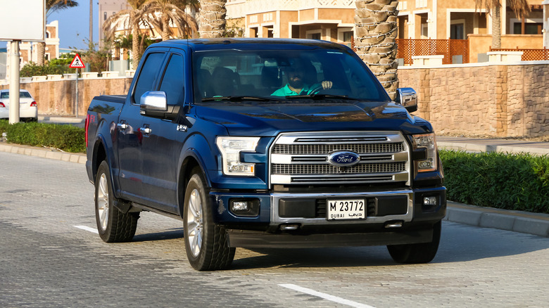 Ford F-150 driving down street