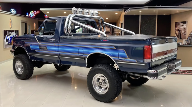 A 1987 Ford F-250 Bigfoot Cruiser truck parked on display.