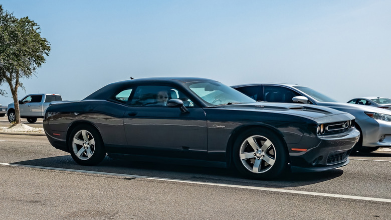 A side on shot of a gray 2015 Dodge Challenger driving