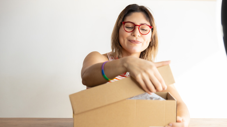 Girl opening a box on a table