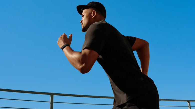 Man running while wearing a Fitbit Air