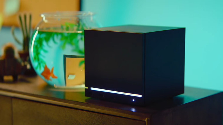 Steam Machine on a sideboard next to fish bowl