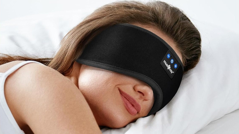 A woman is sleeping wearing Musicozy sleep headphones