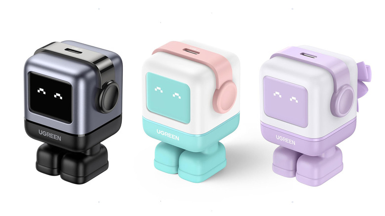 Three colors of the same Ugreen robot-shaped iPhone charger is shown in a row
