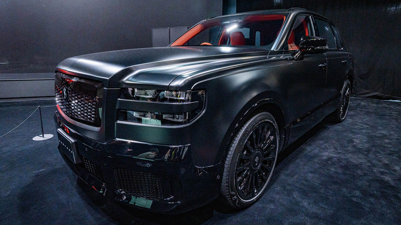 Dark green Century SUV on display at a motor show