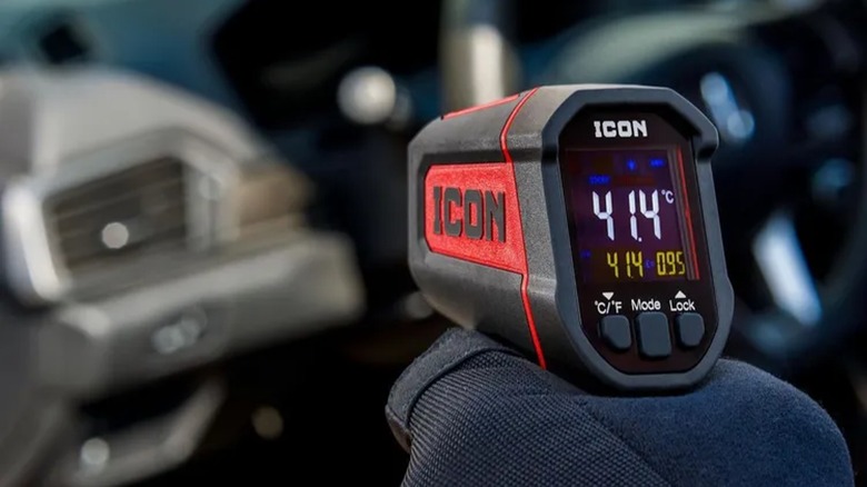 Icon infrared thermometer directed toward a car's AC outlet.