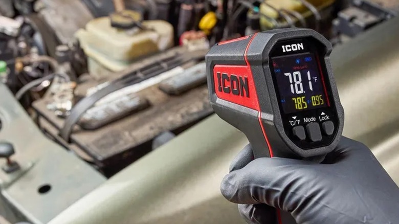 Directing an Icon infrared thermometer toward a car's engine.