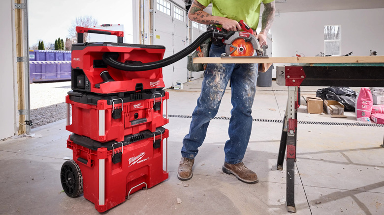 Man using Milwaukee Packout wet-dry vacuum on job site