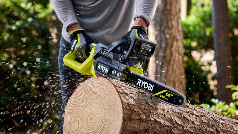 Ryobi 18V One+ HP 14-inch chainsaw sawing through a log
