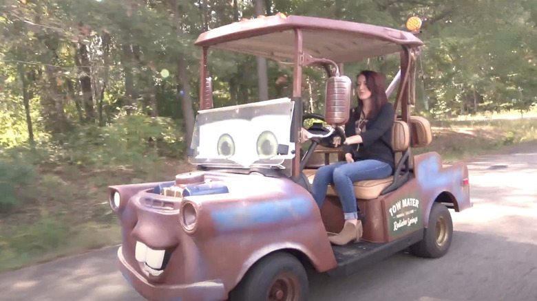 Person driving a Tow Mater golf cart