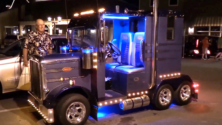 Man looking at semi truck golf cart