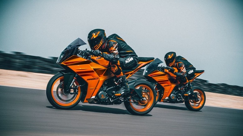 Two men riding KTM 390 motorbikes