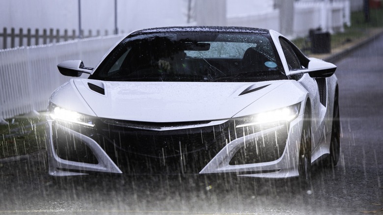 a white Acura NSX in the rain