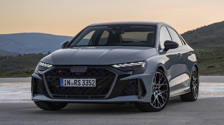 A front-end shot of a gray Audi RS3 parked in a sunset.