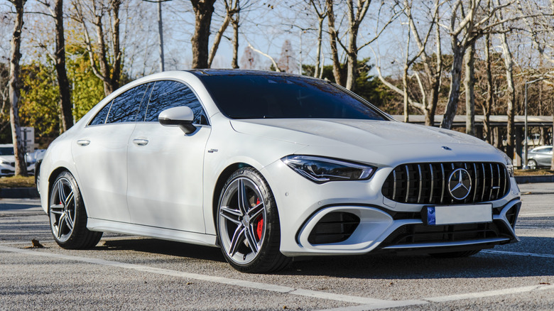 A white Mercedes AMG CLA 45 AMG parked.