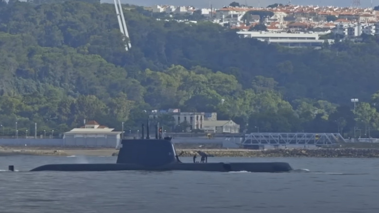 A Chinese (supposedly Shang Class Type 093A) submarine patrolling or being relocated near a Chinese shore