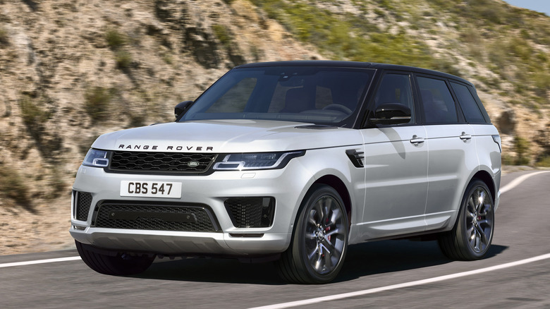 white and black Range Rover Sport on mountain highway