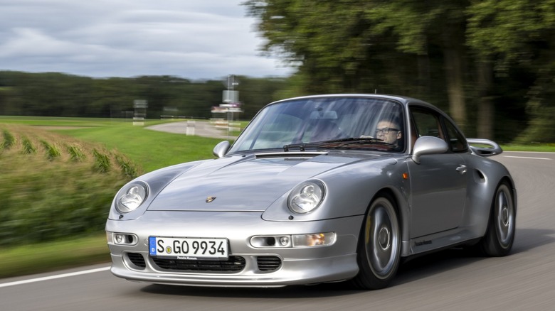 1998 Porsche 911 Turbo S driving on country road, front-left three-quarter view