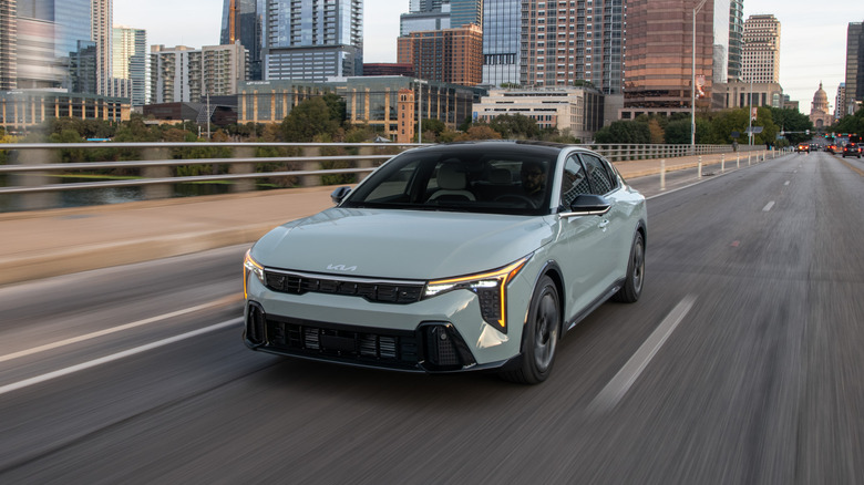 A front-end shot of a 2025 Kia K4 driving