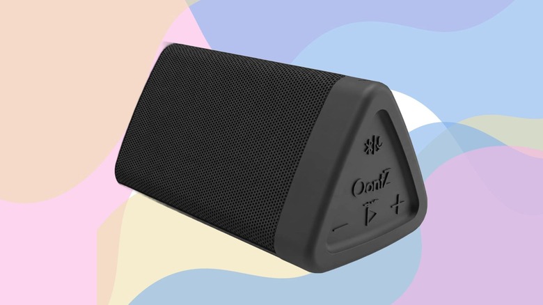 An OontZ Angle 3 Gen 4 Bluetooth speaker against a pastel multicolored background