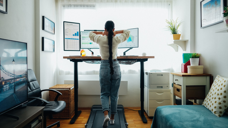 woman working on a desk treadmill