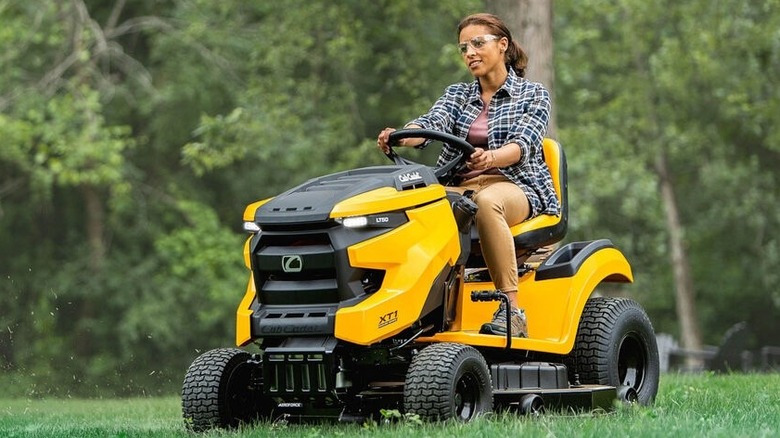 Person riding a Cub Cadet XT1 Enduro LT50 riding mower on a lawn