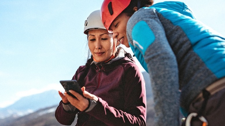 Women using a phone on a hike