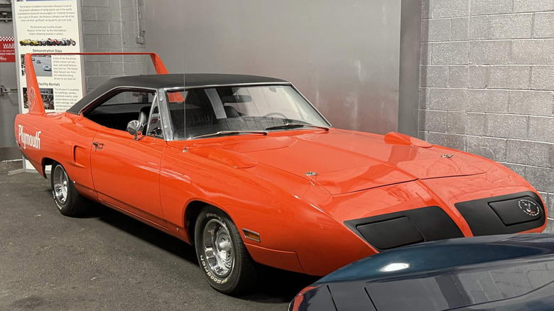Red 1970 Plymouth Superbird on display in museum, front-right 3/4 view