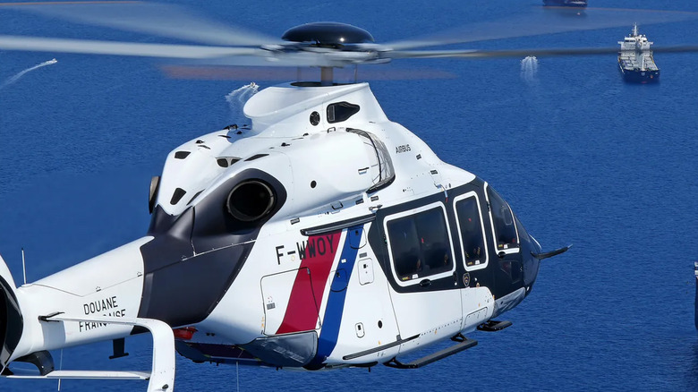 An Airbus H160 flying over water