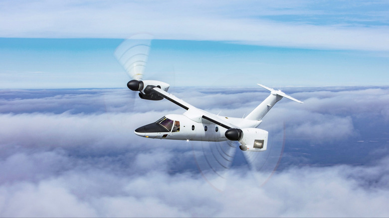 A Leonardo AW609 Tiltrotor flying among the clouds