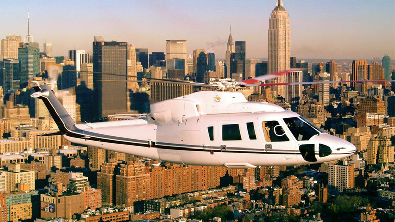 A Sikorsky S-76 flying in a city