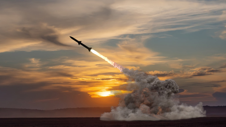 Rocket launching against a sunset background.