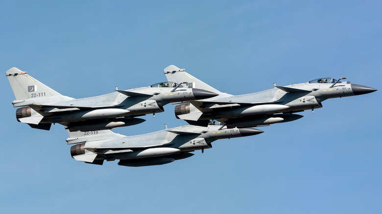 Threee fighter jets in a formation up in the sky