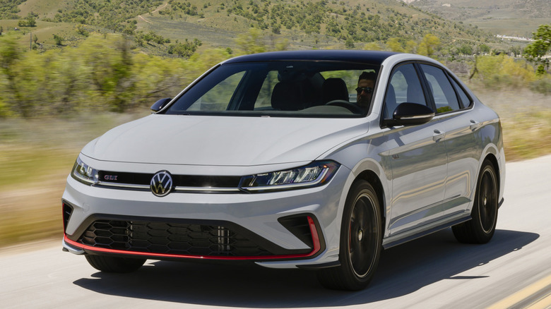Front 3/4 view of VW Jetta GLI on road in hilly setting