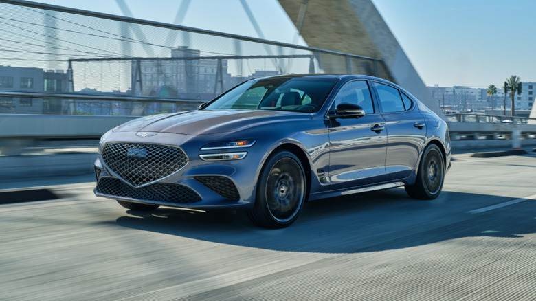 Genesis G70 crossing a bridge in the city