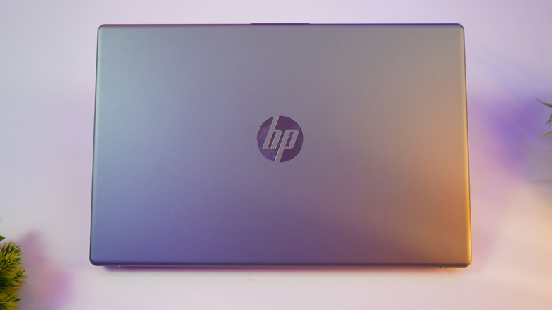 Closed HP laptop resting on a desk.