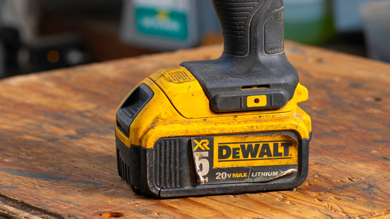 closeup of dirty dewalt battery on power drill