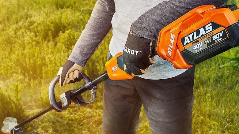 Person using Atlas string trimmer