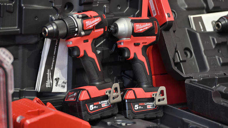 two milwaukee drills with batteries installed