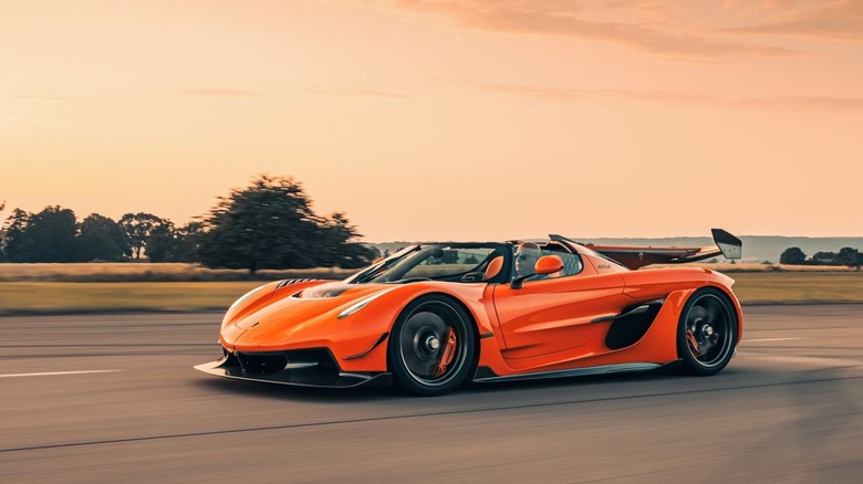 Koenigsegg Jesko Attack driving on open runway, front-left 3/4 view