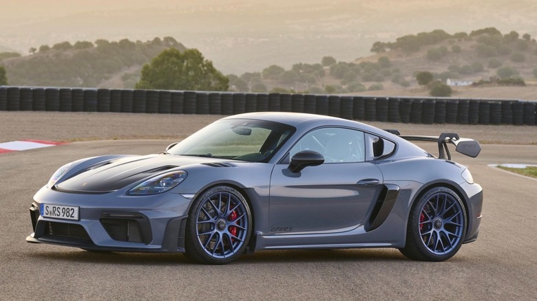 Porsche Cayman GT4 RS parked on racetrack, front-left 3/4 view