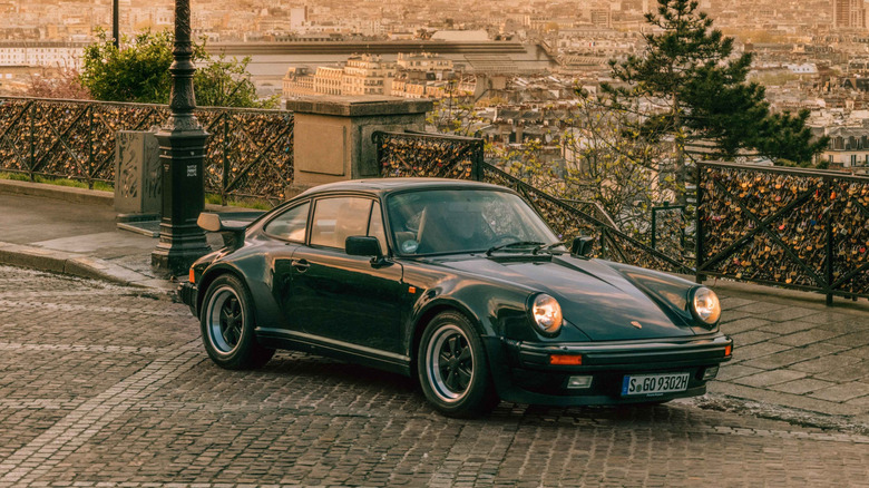 Porsche 911 Turbo 930 generation front 3/4 view with Paris in the background