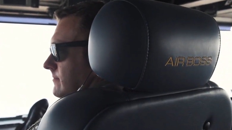 The Air Boss aboard the USS Dwight D. Eisenhower sitting in his "perch" while wearing sunglasses