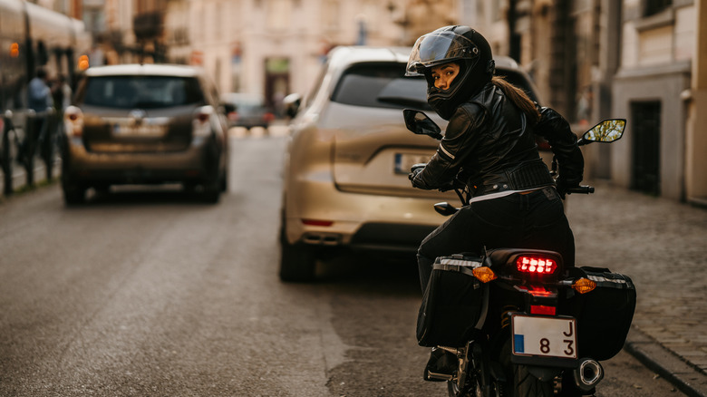 Motorcycle rider looks over her shoulder