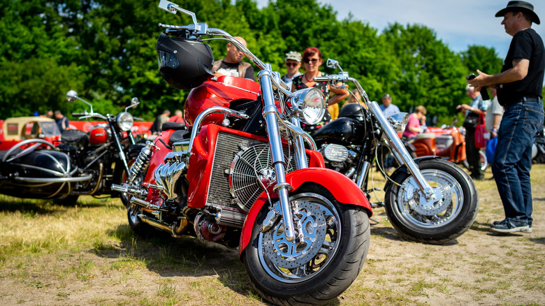 Boss hoss motorcycle parked in front of trees