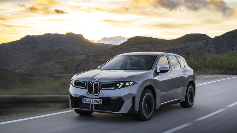 front left view of grey BMW iX3 on mountain highway