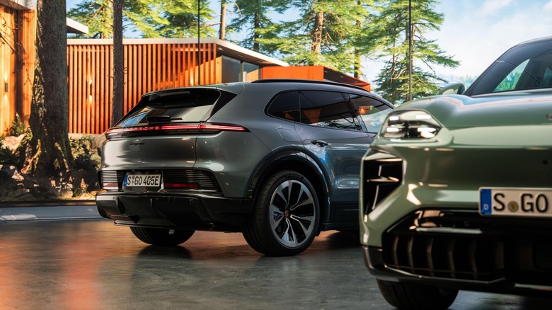 Front and rear views of Porsche Cayenne EVs parked in slate driveway