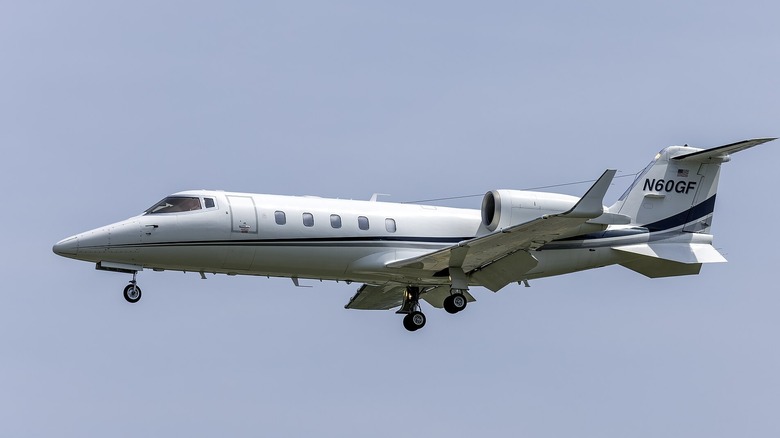 Learjet 60 in flight with landing gear down