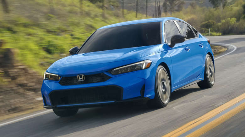 Honda Civic driving at speed on a rural mountan road